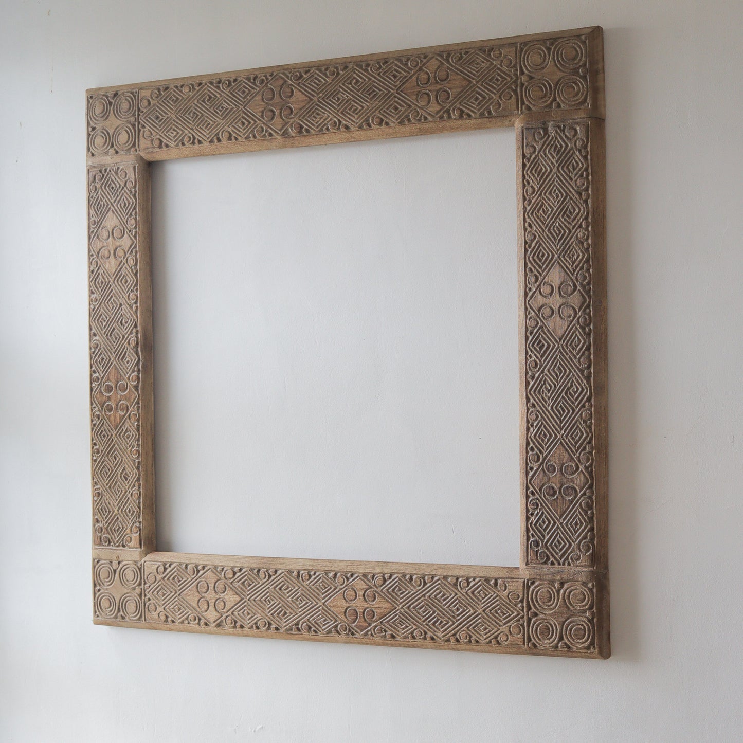 Hand-carved ethnic mirror frame from Bali, 100 cm, showcasing unique wood motifs, perfect for home decor.