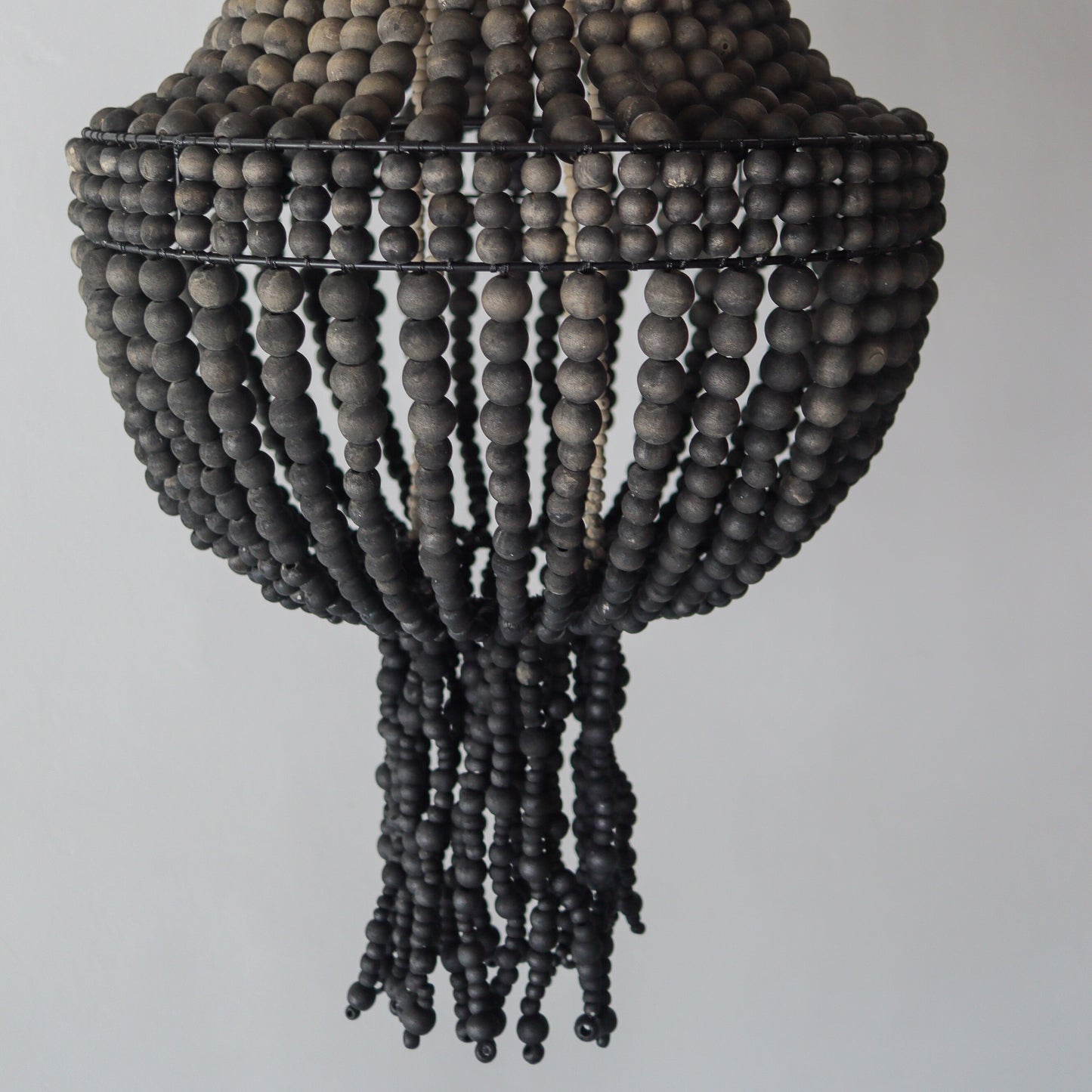 Beaded chandelier in ombre black design, handcrafted from Bali, perfect for unique home decor.