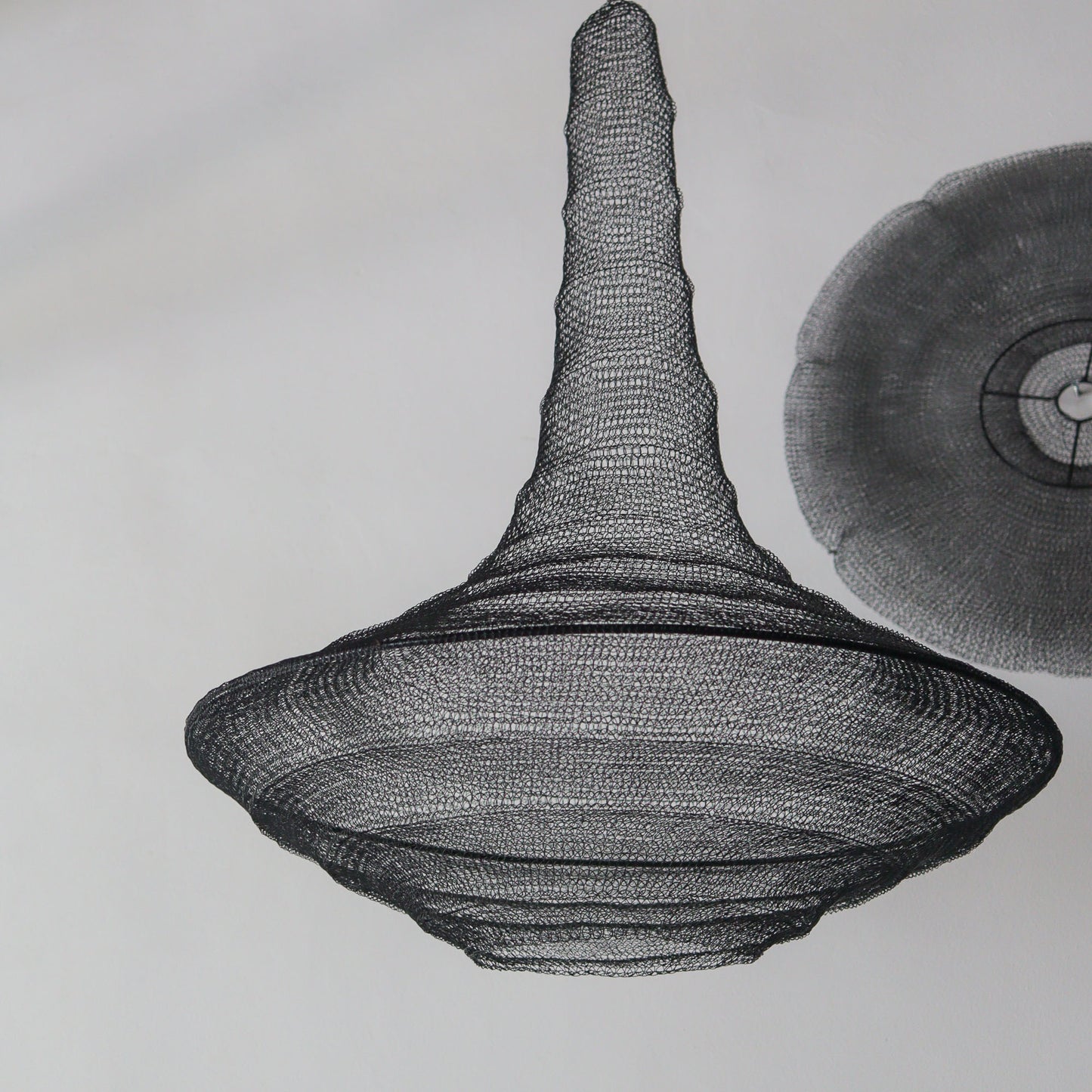 Large black wire mesh chandelier in teardrop shape, handcrafted iron design from Bali, Indonesia.