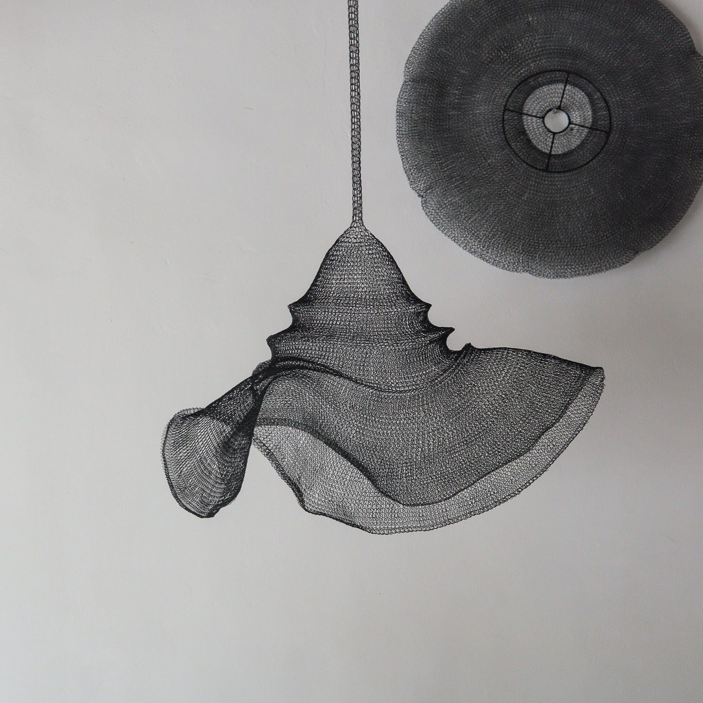 Large black wire mesh chandelier in hat shape, handcrafted from copper mesh iron, perfect for unique interior decor.