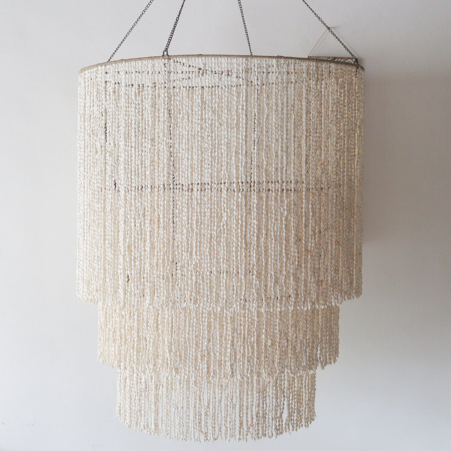 Large seashell chandelier with tiered design, handcrafted in Bali, Indonesia, perfect for elegant decor.