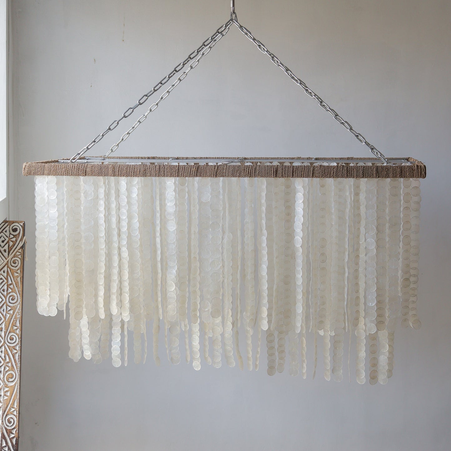 Handmade rectangle Capiz shell chandelier with unique seashell motifs, perfect for home decor.