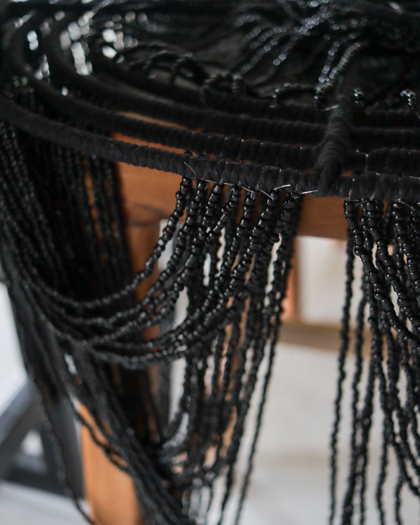 Close-up of black beaded chandelier design showcasing intricate beadwork and unique handcrafted motifs.