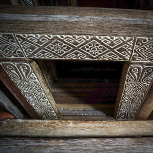 Hand-carved Balinese wood door frame with intricate traditional patterns
