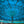 Balinese turquoise parasol umbrella with ornate hand-painted patterns and tassel fringe