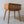 Handcrafted wooden bedside table with woven rattan drawer in minimalist room