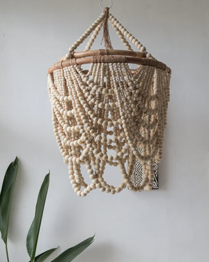 Handcrafted beige beaded ceiling light with natural wood beads and boho decor style.
