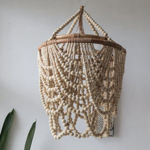 Bohemian beaded chandelier with natural wood beads in a modern minimalist interior setting