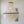 Natural capiz shell chandelier with round shells in a tiered hanging design against a white wall.