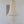 Capiz shell chandelier hanging in a minimalist room with tribal wall art decor.