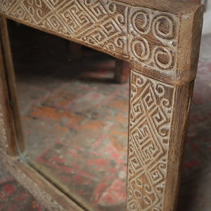 Hand-carved wooden mirror frame with intricate geometric Balinese patterns