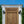 Hand-carved vintage Balinese wooden door with ornate detailing and iron studs outdoors