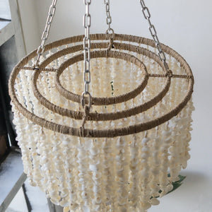 Handmade seashell chandelier with natural twine and metal chains, perfect for boho decor