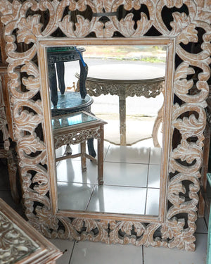 Hand-carved wood mirror with intricate Balinese floral patterns and ornate frame