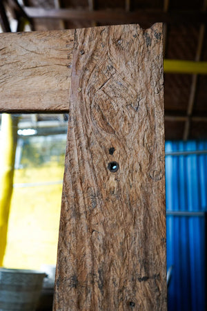 Close-up of hand-carved wooden door frame with natural wood grain texture