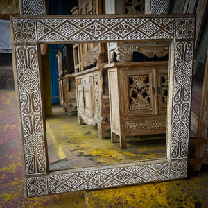 Hand-carved Balinese wooden mirror frame with intricate geometric patterns