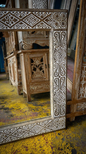 Hand-carved Balinese wooden frame with intricate patterns and rustic finish
