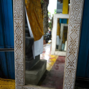 Hand-carved Balinese mirror with intricate geometric wood frame, artisan home decor