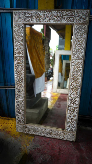 Hand-carved Balinese mirror with intricate geometric wood frame, artisan home decor