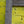 Close-up of reclaimed teak wood frame against textured yellow brick wall