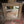 Hand-carved Balinese wood mirror with intricate geometric patterns on a rustic floor