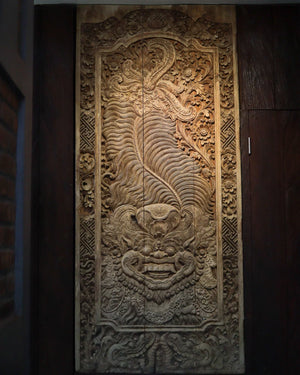 Hand-carved Balinese wood wall panel with intricate floral and mythological motifs