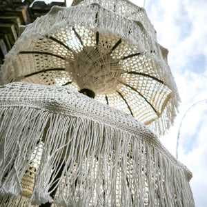 Handcrafted Balinese garden parasols with white crochet and fringe details outdoors
