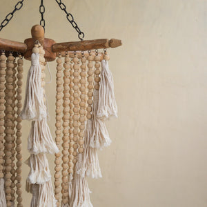Handcrafted chandelier with wooden beads and cotton tassels, boho home decor