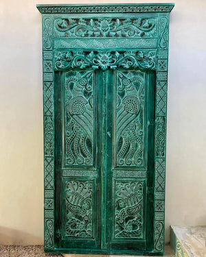 Hand-carved vintage double door with intricate Balinese floral and geometric patterns