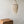 Handmade seashell chandelier with intricate beaded strands above a carved wooden table