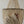 Hand touching strands of natural seashell chandelier with intricate Balinese design