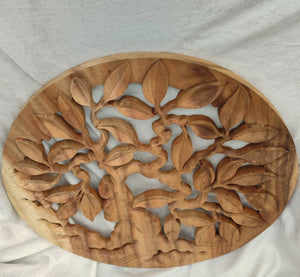 Hand-carved wooden wall art with intricate tree and leaf design Balinese decor