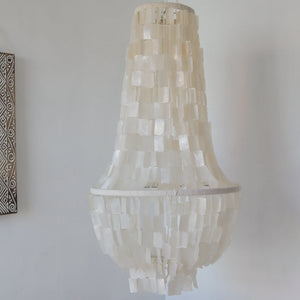 Handmade seashell chandelier with cascading white shell squares, boho home decor style