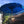 Blue Balinese parasol with tassels in tropical garden courtyard, traditional decor