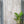Hand-carved Balinese wooden door with floral patterns, potted plant beside entrance