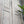 Hand-carved Balinese wooden door with floral engravings and rustic finish outdoors