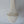 Handmade Balinese seashell chandelier with cascading white shell strands against a gray wall