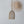 Handwoven rattan pendant light with intricate sunburst bamboo wall decor on white wall