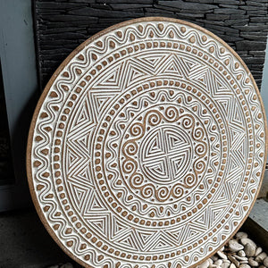 Hand carved ethnic wall panel decoration with intricate patterns from Bali, Indonesia.