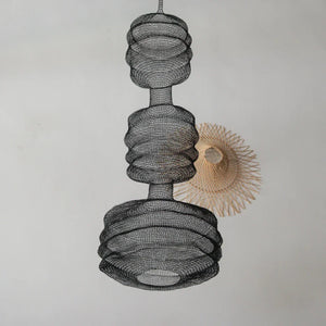 Modern black wire mesh pendant light with geometric shape and a woven rattan ceiling decor