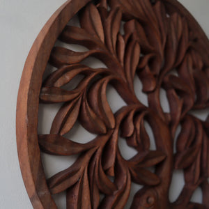 Hand-carved wooden wall art with intricate leafy pattern, Balinese home decor.