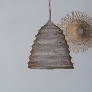 Handmade rattan pendant lamp with woven texture and natural wood wall decor on white background