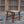 Handmade wooden stool with woven seat on stone patio, rustic Balinese furniture