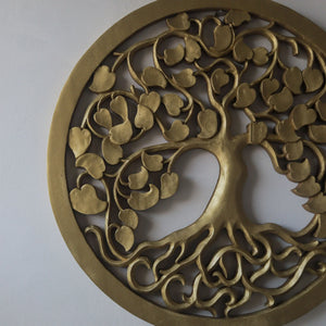 Hand-carved gold wooden tree wall art with intricate roots and leaves on white background
