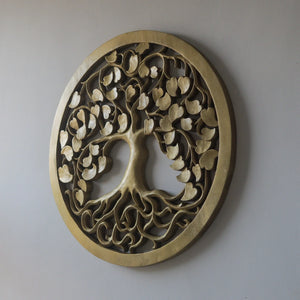 Hand-carved wooden wall decor in gold, featuring a round tree of life design