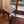 Handmade wooden stool with woven seat in a cozy living room by a glass door
