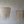 Handmade Balinese seashell chandeliers with draped natural shell strands on a plain wall