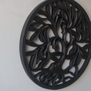 Hand-carved black wood wall art with intricate tree and leaf design, Balinese home decor