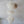 Large white seashell chandelier with round capiz shells, hanging against a plain wall
