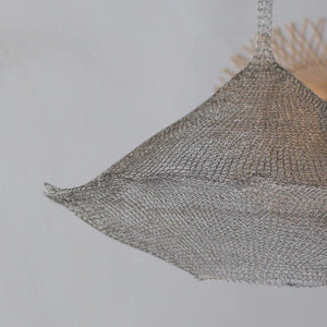 Handwoven wire mesh pendant light with geometric shape hanging from ceiling